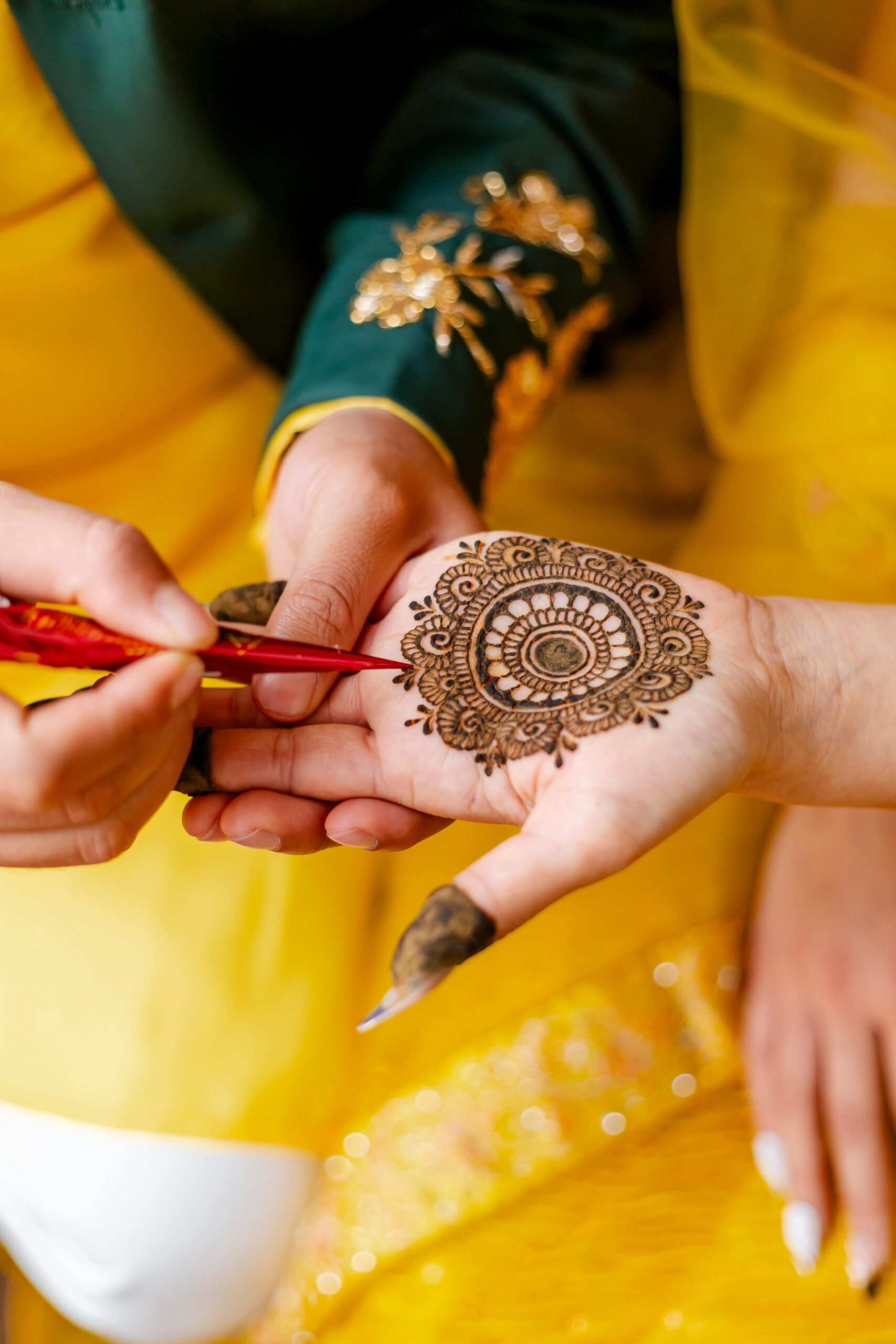 Applying mehandi on hands